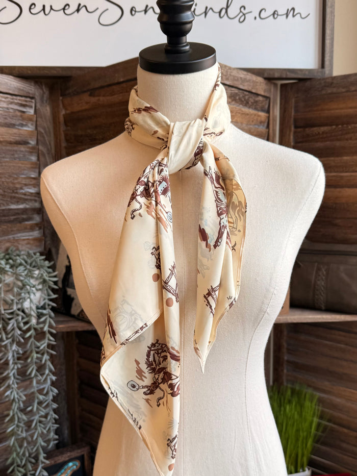 Wild rag scarf, cream with brown cowboy and bronco print, neatly knotted at collar