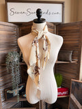 Wild rag scarf in cream with brown western horse and rider print, tied bow at neck