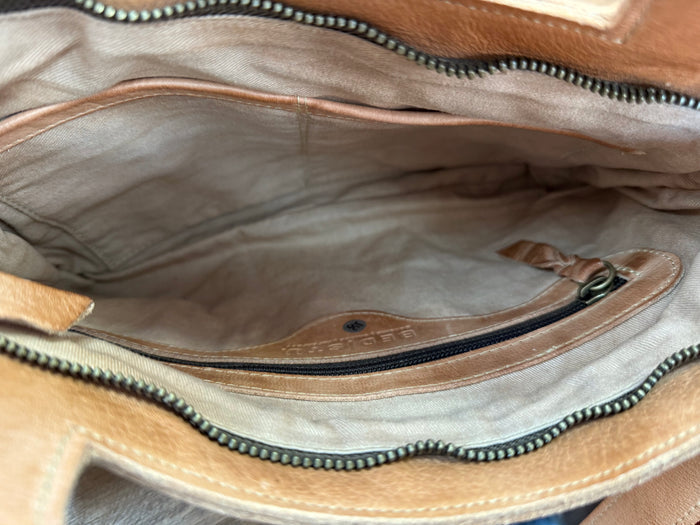 Open tan leather crossbody purse interior with fabric lining and zipper pocket