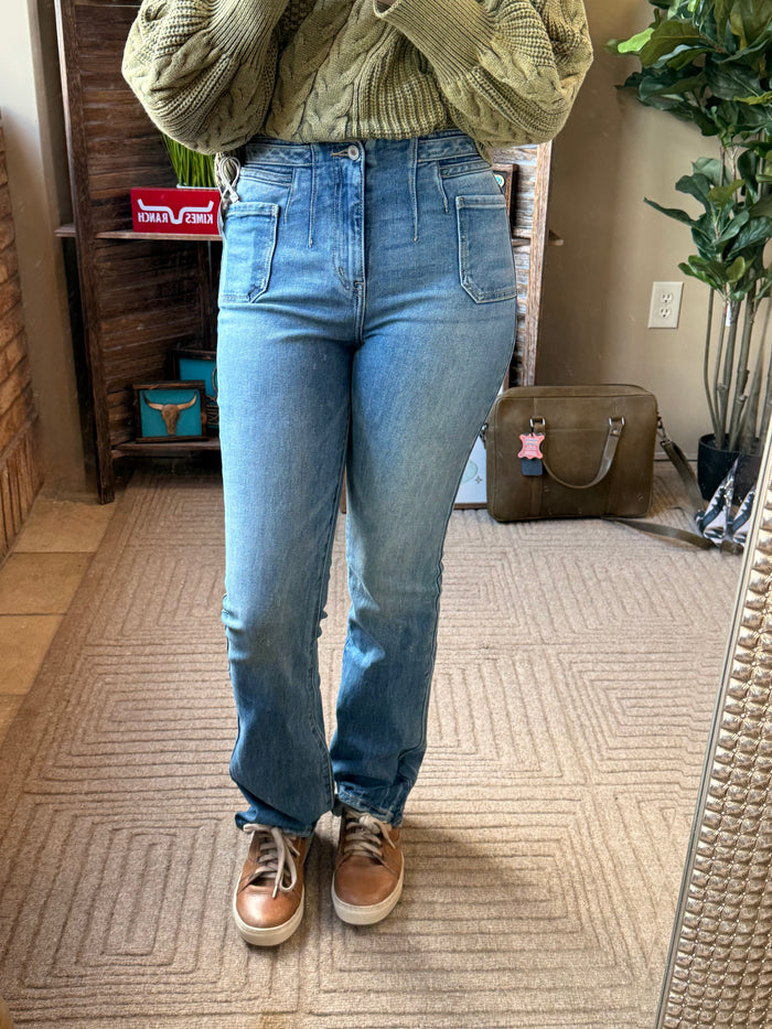 Women's light blue boot-cut jeans with patch pockets and button waist