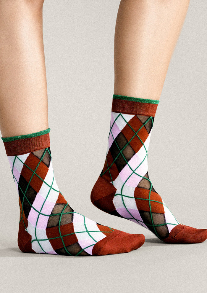 Colorful argyle patterned socks on a neutral background