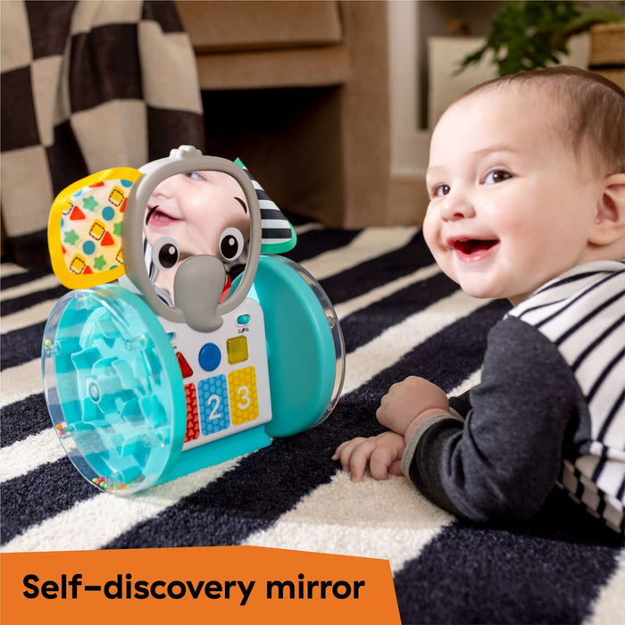 Baby playing with Baby Einstein Chase & Tap Earl interactive crawling toy featuring self-discovery mirror and colorful buttons
