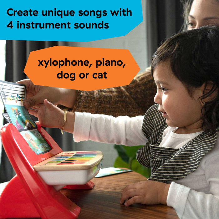 Baby playing with Baby Einstein First Tunes piano featuring xylophone, piano, dog and cat sounds