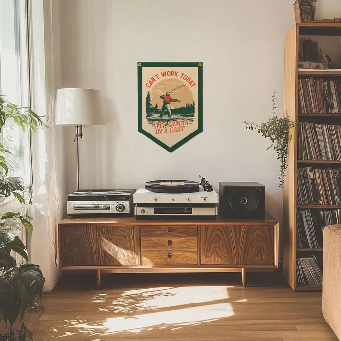 Mid-century wooden console with turntable, speakers, and Benoit’s “Can’t Work Today Arm In A Cast” felt banner above.