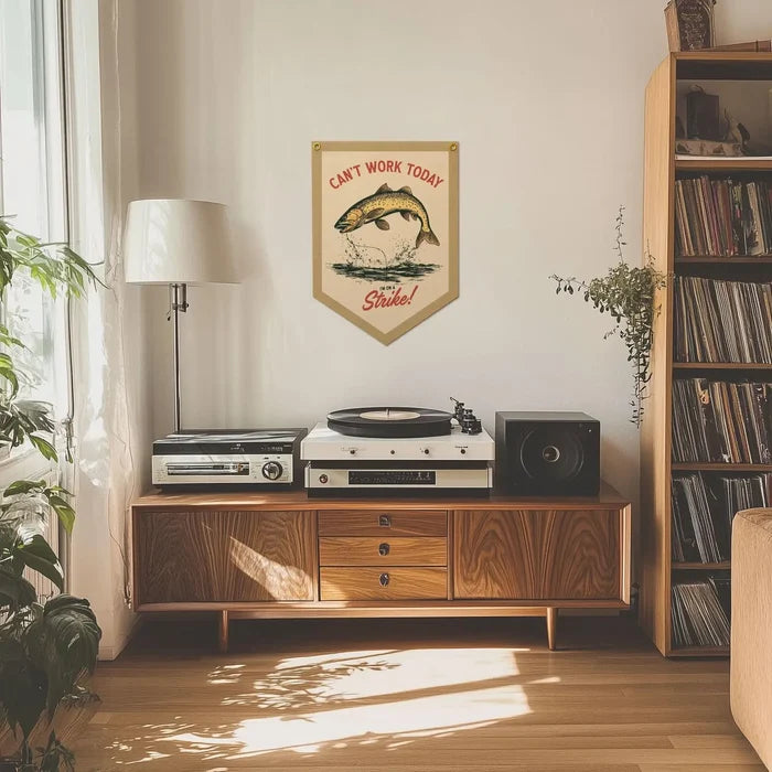 Can’t Work Today I’m On Strike Benoit pennant banner hangs above mid-century console table with speakers and home decor.