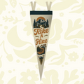 Forager Provisions LTD Take A Hike felt pennant featuring vintage mountain and hiking boot graphics on a wooden desk.