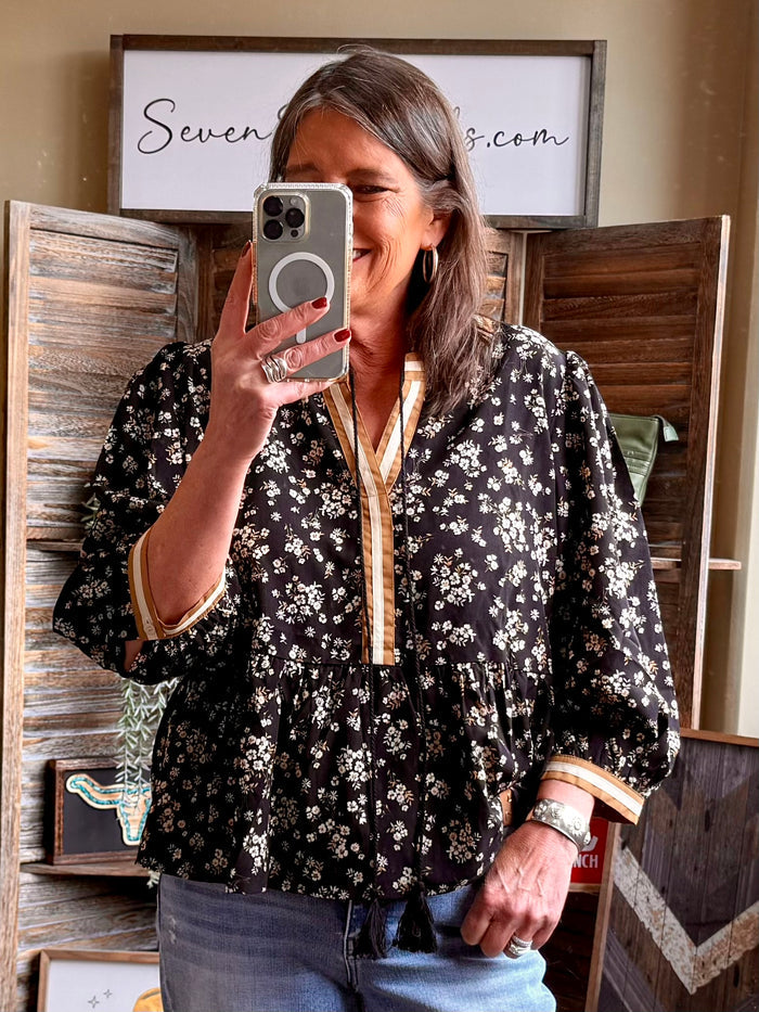 Black floral 3/4 sleeve blouse with button placket and gathered waist