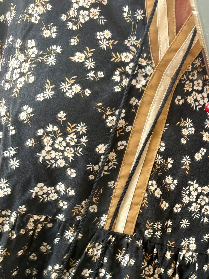 Black floral blouse fabric with small light flowers and tan trim detail