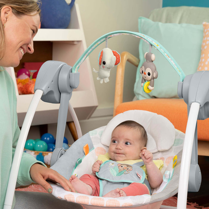 Bright Starts Whimsical Wild Portable Swing with toy bar, soothing melodies, and adjustable harness.