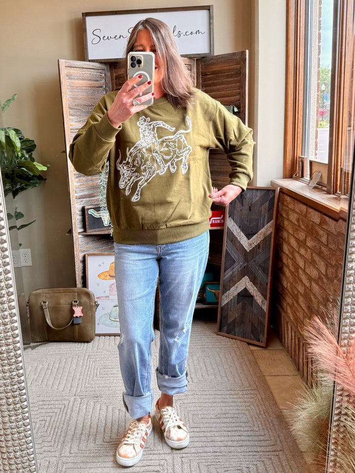 Olive crewneck sweatshirt with white embroidered bull rider design on chest
