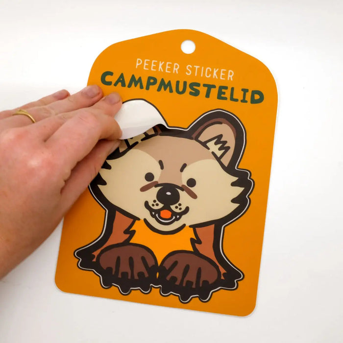 Forager Provisions LTD Camp Mustelid American Marten peeker sticker on orange backing card held by a hand