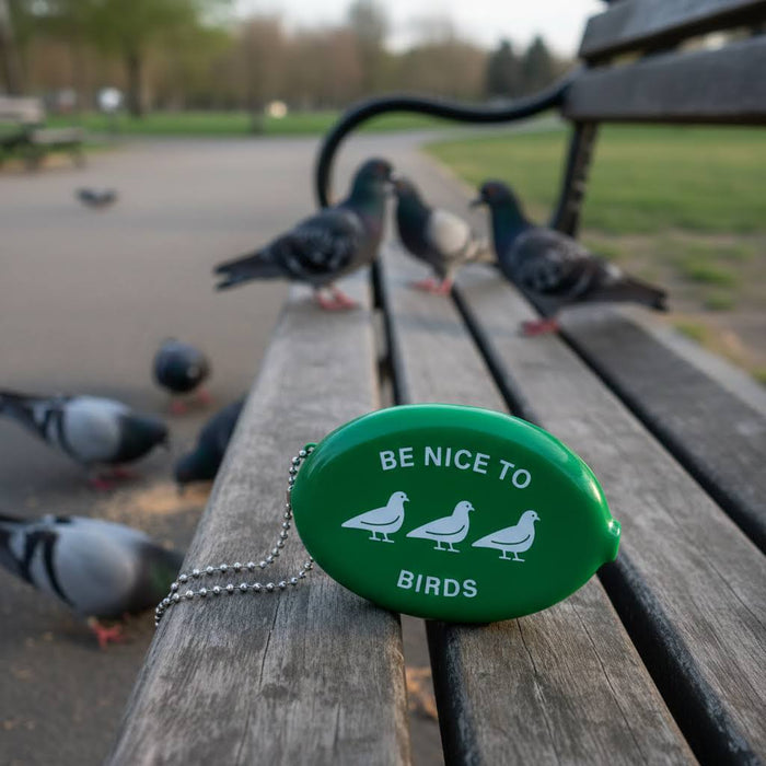 Forager Provisions LTD grass green rubber coin wallet with Be Nice To Birds text and pigeon icons on a park bench.