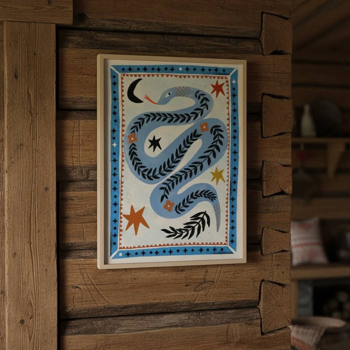 Carole Hillman French Folk Snake Serpent A4 print adds rustic charm as unique wall art in a cozy wooden cabin interior.