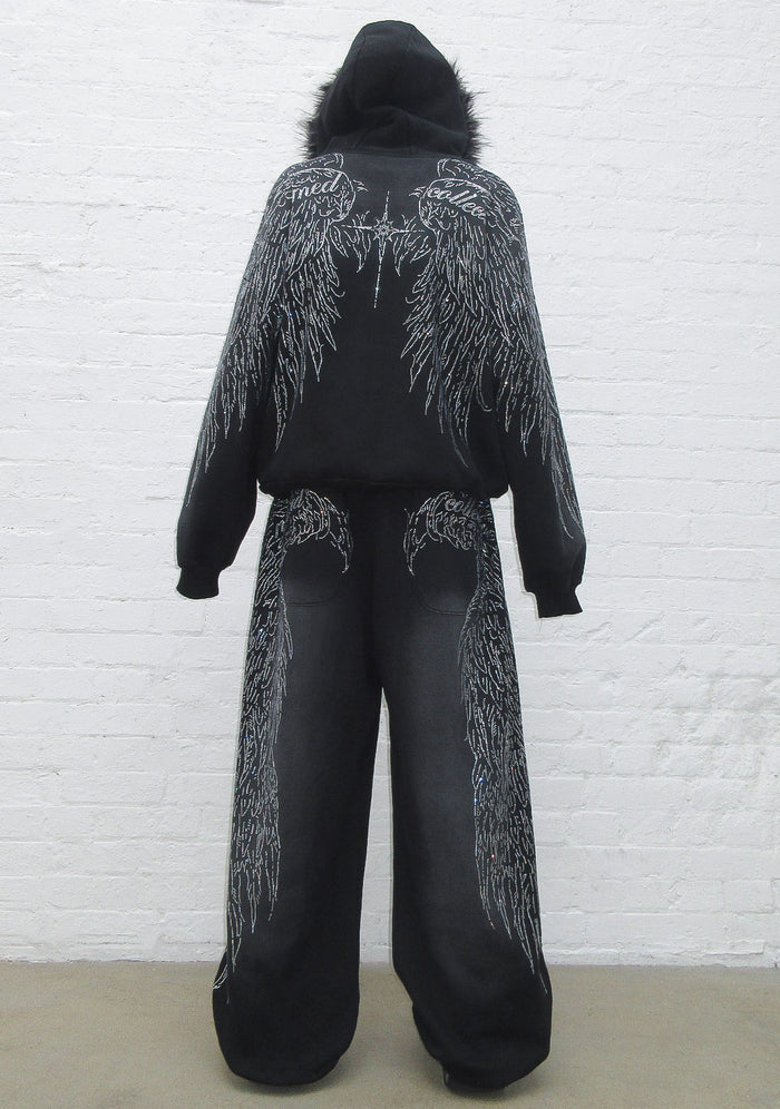 Back view of oversized sweatpants in black featuring rhinestone wing design and two back pockets.