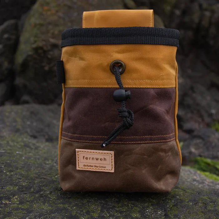 Fernweh UK waxed canvas chalk bag in Sand/Bracken/Bark, perfect for climbing, displayed outdoors beside rocks.