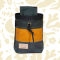 Fernweh UK Waxed Canvas Chalk Bag in Sand/Scree, Scottish handcrafted climbing gear on floral background, premium quality.