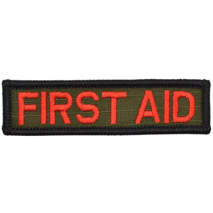 A rectangular first aid patch with red text on a green background.