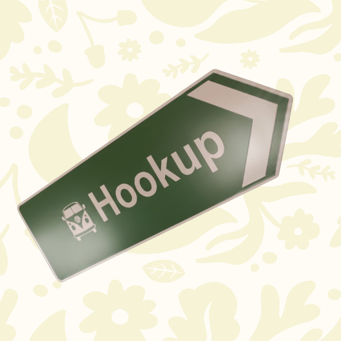 Forager Provisions green aluminum sign (45x15) with “Hookup”, van icon, arrow, floral backdrop. Camping gear decor.
