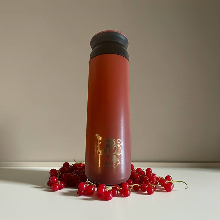 Forager Provisions Currant Berry 500ml Travel Mug with black lid on white surface, surrounded by fresh red currants.