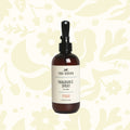 Against a plain white background, a brown bottle of Fox + Hound Dog Fragrance Spray, labeled "Redwood Amber," offers a long-lasting scent and serves as an effective pet odor solution.
