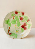 A ceramic plate in ivory with hand painted raspberry motif.