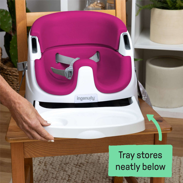 Pink Ingenuity Baby Base 2-in-1 Booster Seat attached to dining chair with removable tray for feeding and play