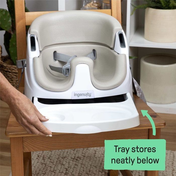 Ingenuity Baby Base 2-in-1 baby booster seat in cashmere attached to dining chair with removable tray