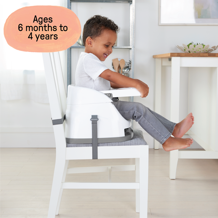 Ingenuity Baby Base 2-in-1™ Seat in slate attached to dining chair with removable tray and harness for babies and toddlers