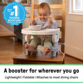 Ingenuity Deluxe Comfort folding baby booster in grey with cushioned seat and adjustable tray