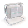 Ingenuity Dream & Grow Bedside Bassinet with adjustable height, breathable mesh sides, soothing sounds, and lockable wheels for baby comfort and safety