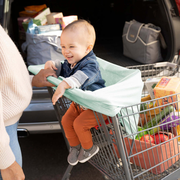 Ingenuity Good to Go 4-in-1 Multi-Use Cover in fern green for nursing, stroller, shopping cart, and high chair use