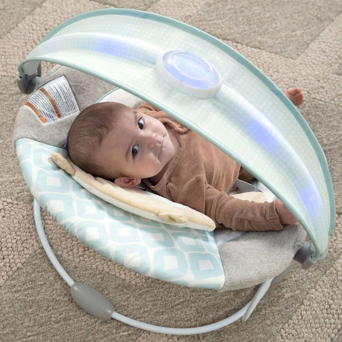 Ingenuity InLighten baby bouncer seat with light-up toy bar and plush fox bolster
