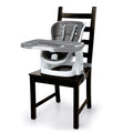 Ingenuity SmartClean ChairMate portable high chair and toddler booster seat in slate color attached to dining chair