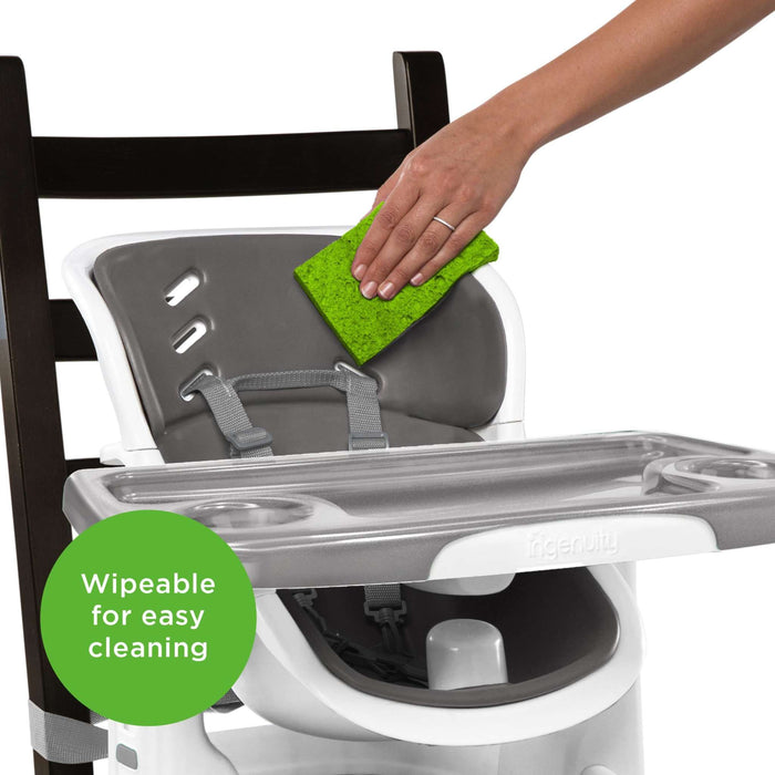 Ingenuity SmartClean ChairMate portable high chair and toddler booster seat in slate color attached to dining chair