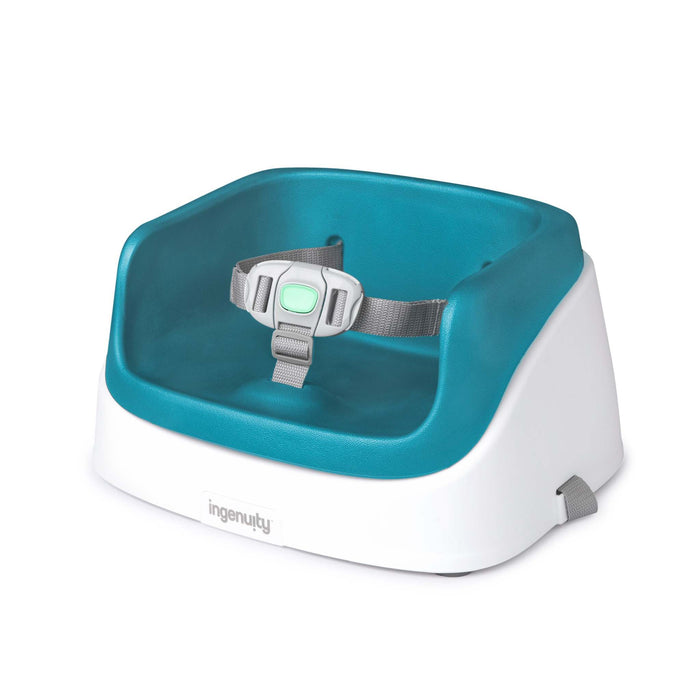 Ingenuity SmartClean Toddler Booster Seat in Peacock Blue with removable foam insert and 3-point harness on dining chair