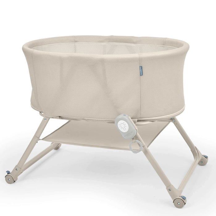 Ingenuity Snooze & Stow™ Easy-Folding Bassinet in sand color with sound, light, and vibration features for baby sleep and portability
