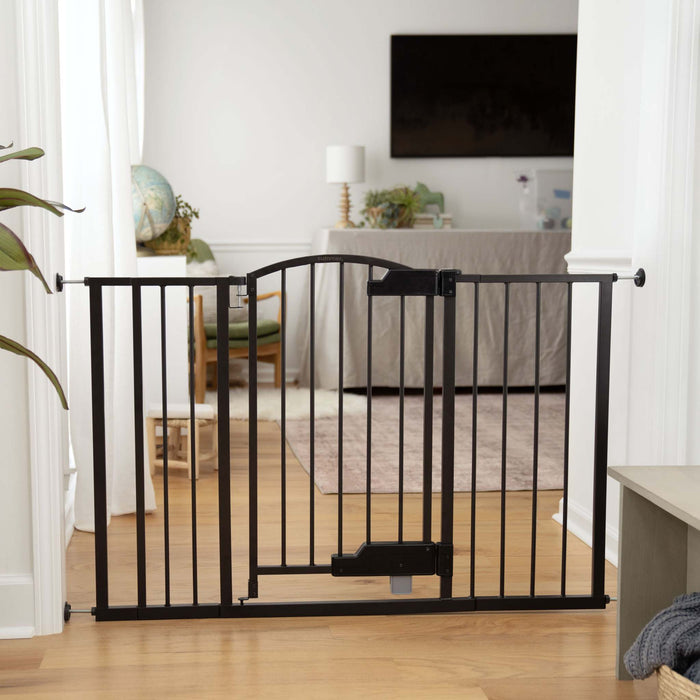 Ingenuity The Thruway 52W Series baby and pet gate with GlideOpen foot pedal and espresso metal finish installed in doorway