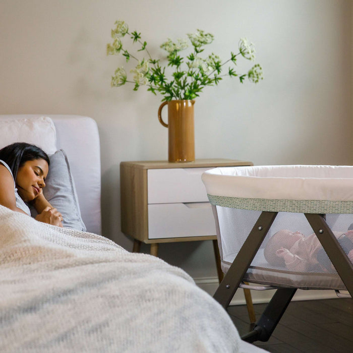 Ingenuity Wood FoldAway Rocking Bassinet with breathable fabric and foldable frame for easy portability