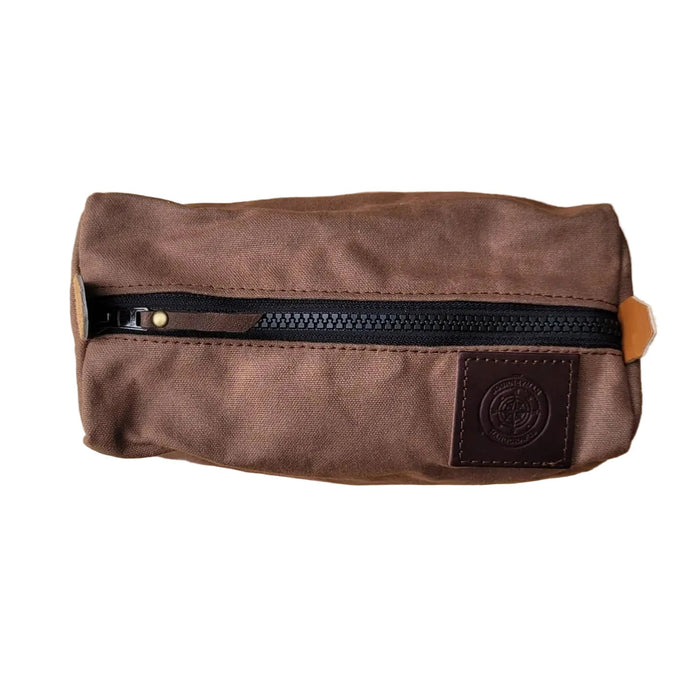 Forager Provisions LTD brown waxed canvas camping peg case with a rugged black YKK zipper and leather logo patch.