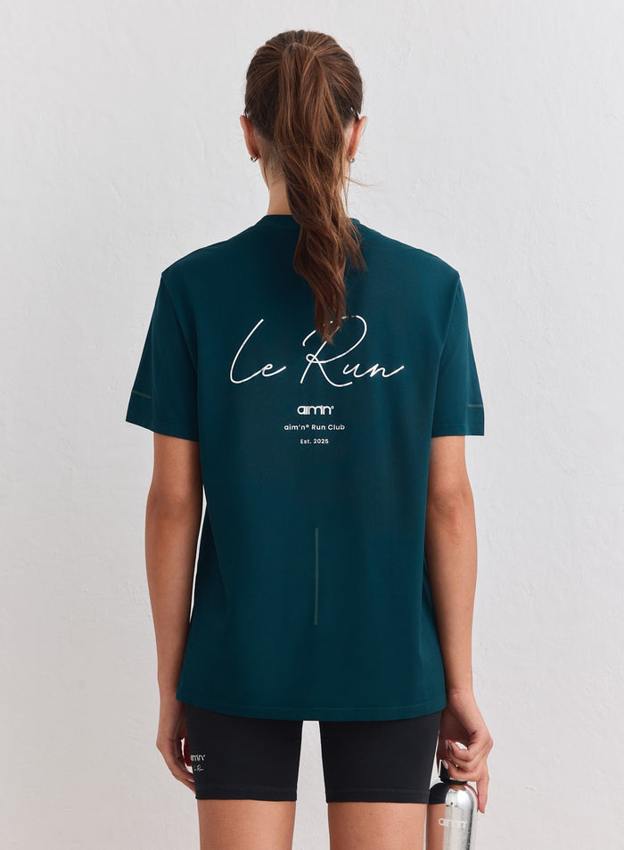 Laguuninvihreä Le Run Seamless Running T-shirt, jossa on valkoinen aim'n-grafiikka selässä. [M-178cm]
