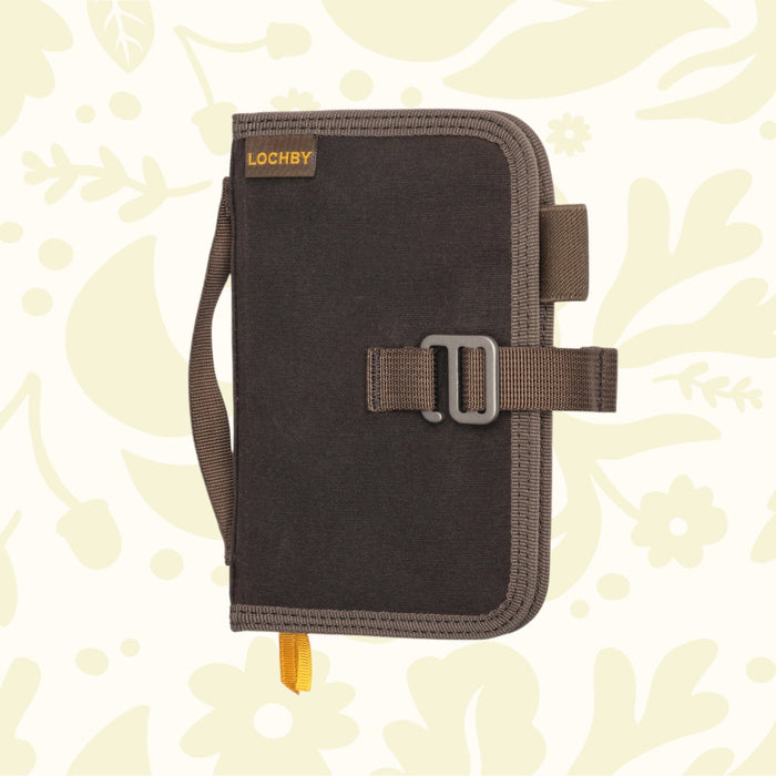 Brown Lochby Mini Field Journal, waxed canvas pouch style with handle & buckle, on floral background—perfect EDC notebook.