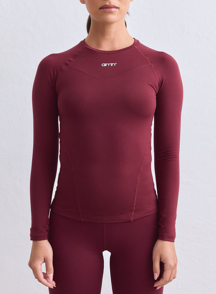 Viininpunainen aim'n Soft Basic Long Sleeve -paita raglanhihoilla ja pienellä rintalogolla. [S-165cm]