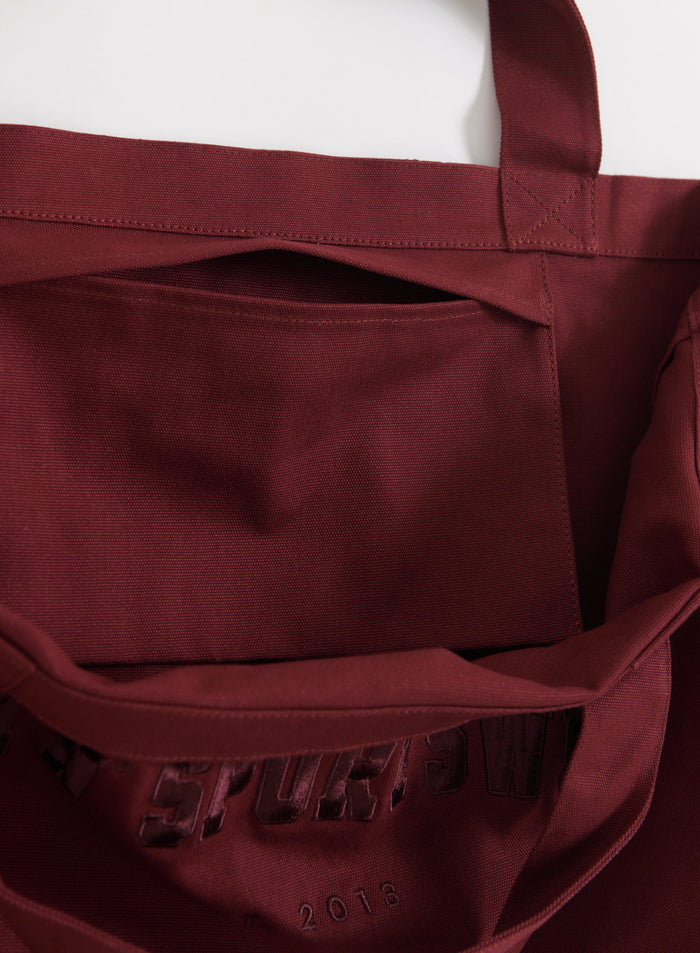 Merlot-värinen puuvillainen aim'n Varsity Tote Bag, jossa on kätevä sisätasku ja kudottu pinta.