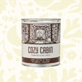 Forager Provisions LTD Moore Collection Cozy Cabin soy wax candle in a rustic metal tin with woodsy scent notes