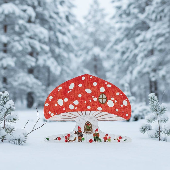 Mortlake Papers Snowy Mushroom Gnome House Card shows gnomes, pine trees, and a mushroom house in a winter wonderland scene.