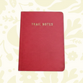 Forager Provisions LTD Trail Notes red pocket-sized field journal for hikers with gold embossed text on the cover.