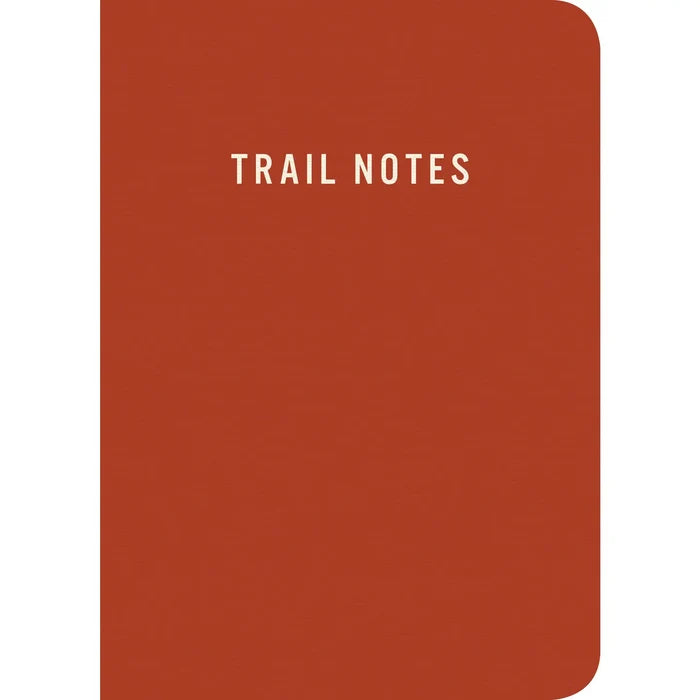 Red Mountaineers Books Trail Notes notebook: rounded edges, white text—ideal for hiking and outdoor notes.