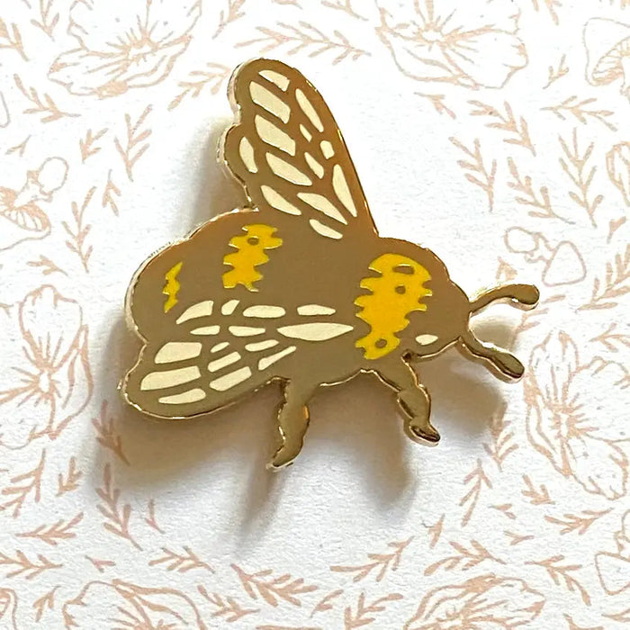 Limited Edition Mustard Beetle Bee Mirrored Pin showcasing an original illustration of a mustard beetle on a decorative backing card adorned with intricate patterns and the text "Mustard Beetle.