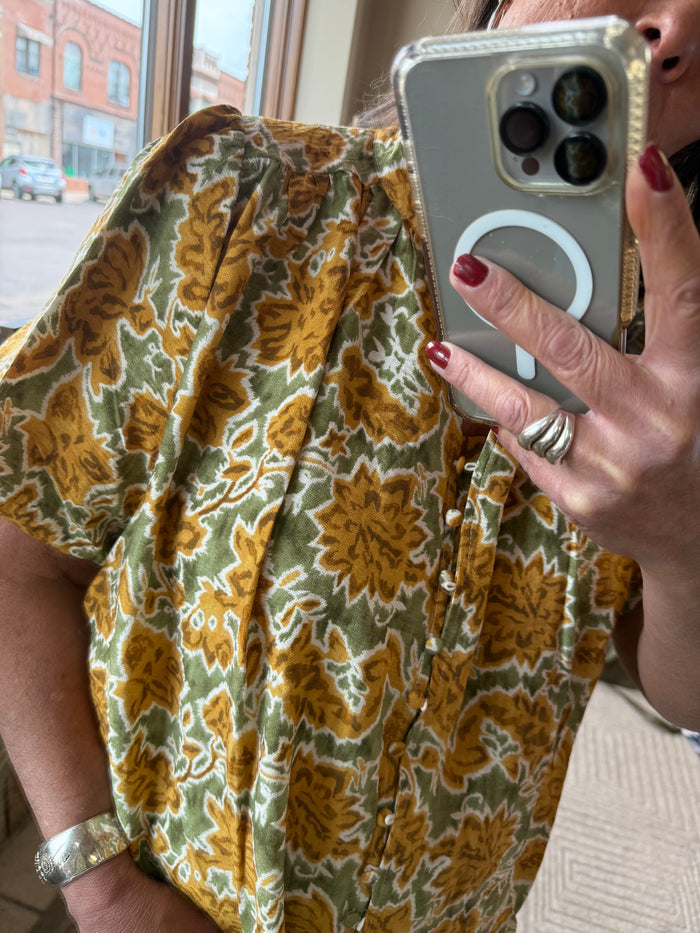 Floral short-sleeve shirt with button placket and rounded neckline