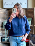 Navy pullover hoodie sweatshirt with hood and front pocket, worn with jeans